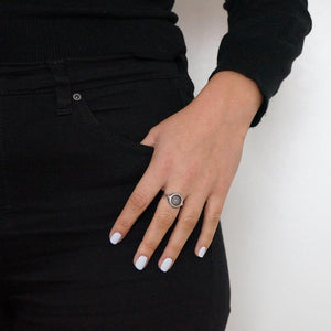 A caucasian female wearing Limed White Nail Polish, a bold, pearly white shade by Paint Nail Lacquer. The female is dressed in back with her hand resting on her side jean pocket