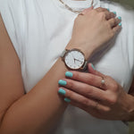 christina vlask showing olivia burton watch and wearing speamint cream nail polish a bright bold aquamarine shade 