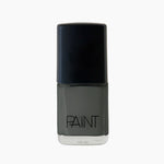 A bottle of Amazon Haze nail polish by Paint Nail Lacquer against a white backdrop, this shade is a dark grey with green undertones.