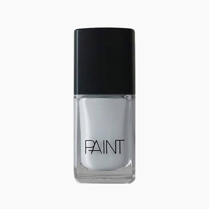 A bottle of Cloud Mist nail polish by Paint Nail Lacquer against a white backdrop, this shade is a light silvery grey colour