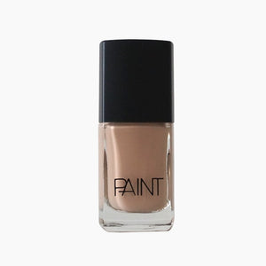 A bottle of Iced Latte nail polish by Paint Nail Lacquer against a white backdrop, this is a light creamy nude brown shade. 