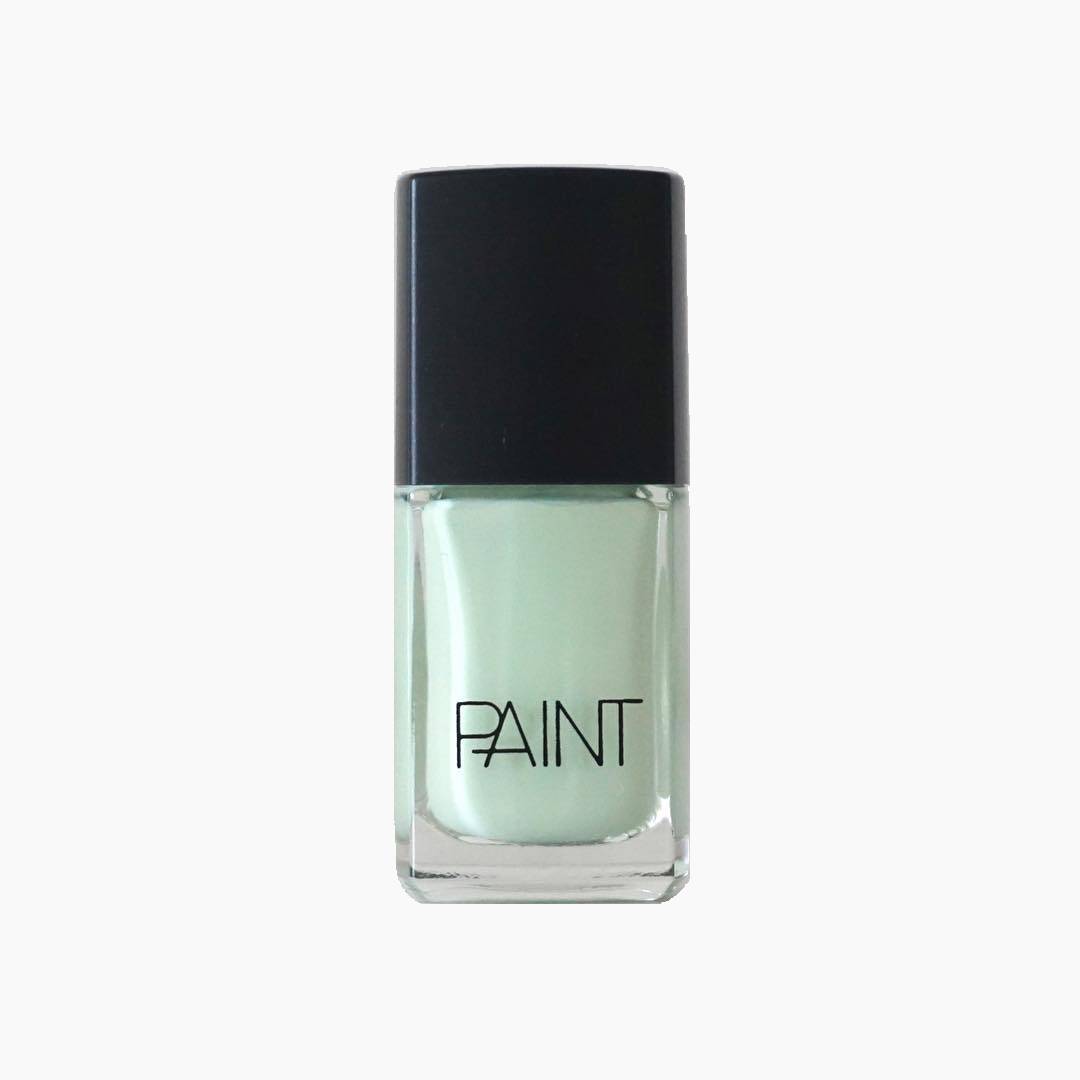 A bottle of Mint Sorbet Nail Polish by Paint Nail Lacquer against a white backdrop, this shade is a light emerald leafy pastel green in colour