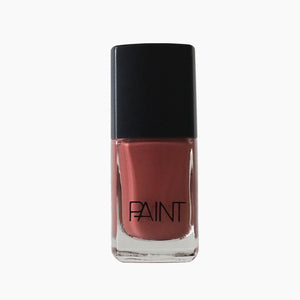 A bottle of Sangria nail polish by Paint Nail Lacquer against a white backdrop, this shade is a medium dark pink 