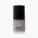 A bottle of Wet Cement nail polish by Paint Nail Lacquer against a white backdrop, this shade is a light grey shade